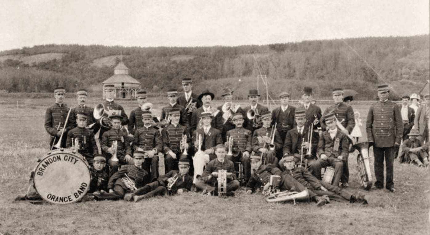 The Brandon City Orange Band marching in full regalia on the Twelfth of July parade, Brandon, Manitoba, 1908